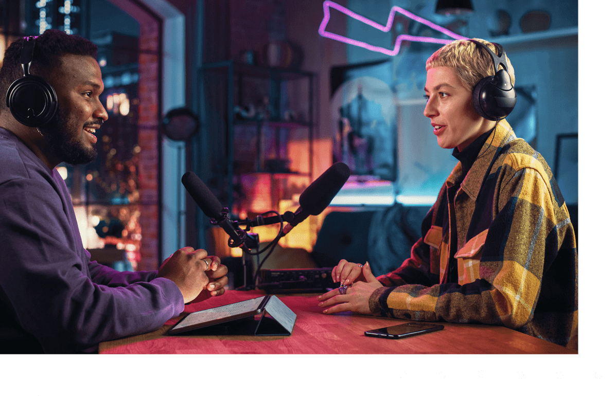 Two people recording a podcast in studio.